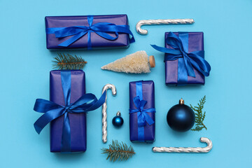 Festive composition with gift boxes and Christmas decorations on blue background