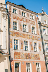 Colorful Historic Buildings and Houses on Stary Rynek Square in Poznań, Poland, with a Blue Sky and Mural Art © explorateurphotos