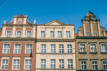Colorful Historic Buildings and Houses on Stary Rynek Square in Poznań, Poland, with a Blue Sky and Mural Art