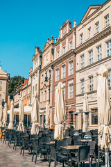 Colorful Buildings on Stary Rynek Square in Poznań, Poland, with Empty Restaurant Terraces under Bright Sunlight