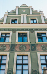 Colorful Historic Buildings and Houses on Stary Rynek Square in Poznań, Poland, with a Blue Sky and Mural Art © explorateurphotos