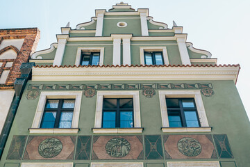 Colorful Historic Buildings and Houses on Stary Rynek Square in Poznań, Poland, with a Blue Sky and Mural Art © explorateurphotos