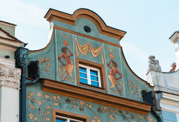 Colorful Historic Buildings and Houses on Stary Rynek Square in Poznań, Poland, with a Blue Sky and Mural Art © explorateurphotos