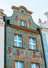 Colorful Historic Buildings and Houses on Stary Rynek Square in Poznań, Poland, with a Blue Sky and Mural Art © explorateurphotos