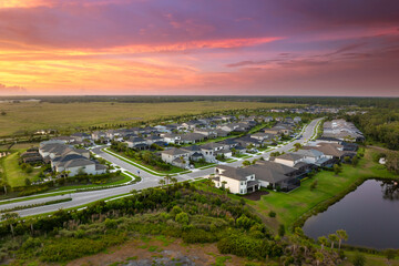 Premium housing development in the USA. Expensive houses between green palm trees in southwest...