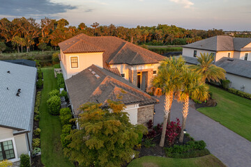 Premium housing development in the USA. Expensive houses between green palm trees in southwest...