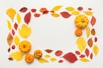 Frame made of autumn leaves and fresh pumpkins on white background