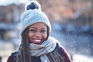Portrait, outdoor and black woman in snow, smile and warm with scarf, park and excited for winter. Travel, tourist and clothes for weather, vacation and visit for festive, happy and person in Canada