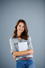 Fototapeta premium Student, tablet and portrait of girl in studio for research assignment, college thesis and online portal. Education, knowledge and elearning with person on gray background for university project