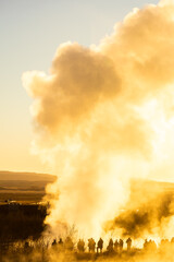 Stokkur geyser spectacular eruption in front of the sun , Iceland