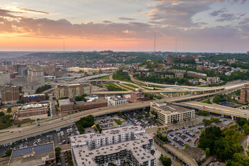 Fototapeta premium View from above of USA transportation infrastructure. Aerial view of American highway junction at sunset with fast driving vehicles in Cincinnati, Ohio
