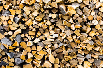 Background of Neatly Stacked Chopped Firewood for Winter