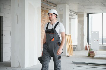 portrait of handsome construction worker on building industry construction site