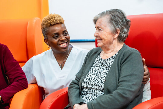African american nurse and senior woman talking in the geriatrics