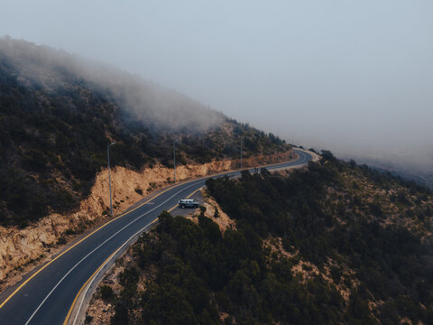 Aerial view of a countryside road surrounded by lush greenery in asir principality