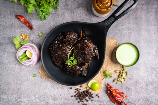 Flat lay of roasted jerk chicken wings dish with sauce