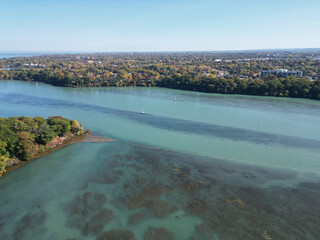 Aerial over Martindale Pond near Port Dalhousie and Lake Ontario in St. Catharines, Ontario, Canada on a sunny Autumn day in October, 2024.