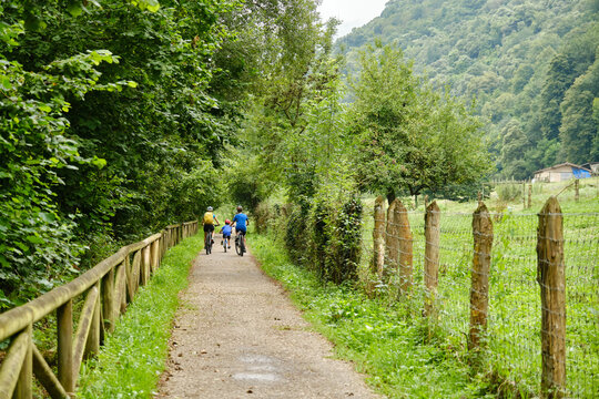 Cyclists riding along the Senda del Oso, Asturias, Spain