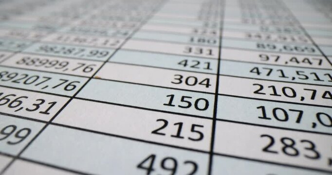 Accountant reviews financial spreadsheet numbers scrolling through data. Analyzing figures and assessing financial performance in office
