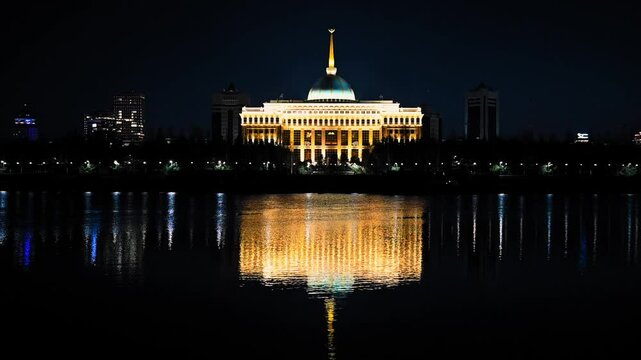 Video night view of Ak orda Presidential Palace in Astana, Kazakhstan, reflecting in the Ishim River with surrounding city skyline