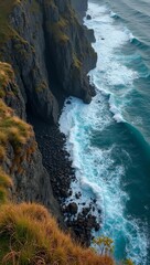 Dramatic coastline with sharp cliffs crashing waves and windswept grasses