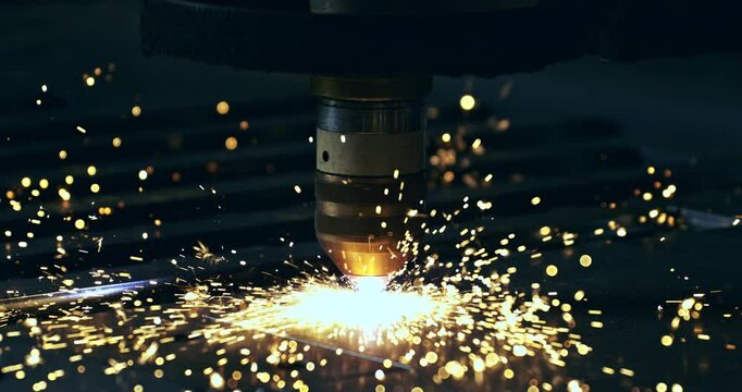 Super slow motion macro of maintenance worker or welder using high-tech industrial welding machine to weld metal steel with flying sparks in workshop or factory setting at 1000 fps.