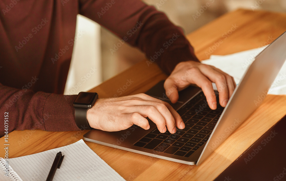 Poster unrecognizable guy using laptop typing, writing article for website working in modern office. select