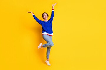 Full length photo of carefree funky girl wear blue pullover rising hands arms empty space isolated...