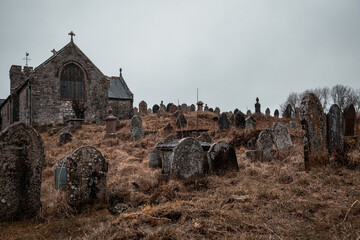 spooky old overgrown cemetery with ancient headstones in Wales UK
