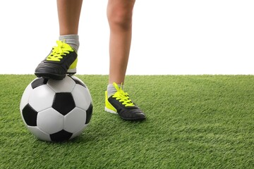Fototapeta premium Football player with soccer ball on artificial grass against white background, closeup. Space for text