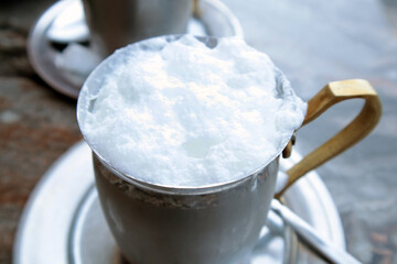 Traditional Turkish foamy buttermilk in a copper mug