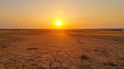 Sunset Over Dry Landscape with Cracked Earth