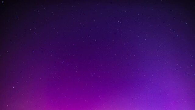 Night sky with aurora borealis as time lapse video. Abstract background of the stars and violet magenta colors due to polar light effects. The beautiful rays are moving through the frame.