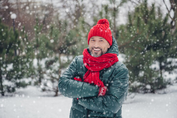 Portrait of satisfied glad person toothy smile crossed arms wear red knitted scarf headwear snowy...