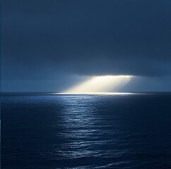 Amazing high resolution photos of the sea and sky of the same dark blue color and only on the horizon a ray of sun, breaking through the bad weather, illuminates the crystal-silver-blue sea. Nature