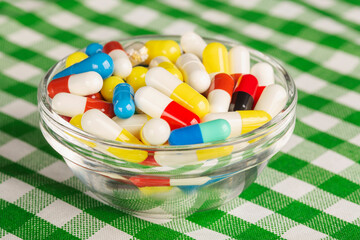 colored medical pills blue, yellow, white on the table