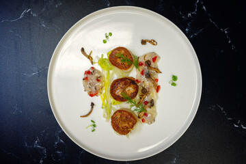 Japanese scallops on a bed of  braised fennel and wild mushrooms
