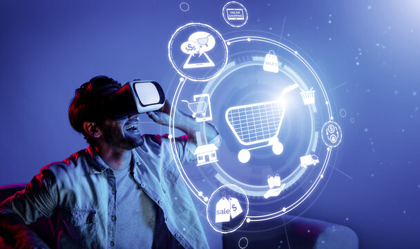 Happy man using VR headset and shopping online while sitting at sofa with shopping bags. Smart person looking at online market hologram and icon with neon background. Innovation technology. Deviation.