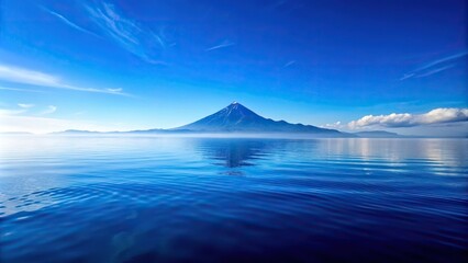 Scenic view of blue ocean with mountain reflection