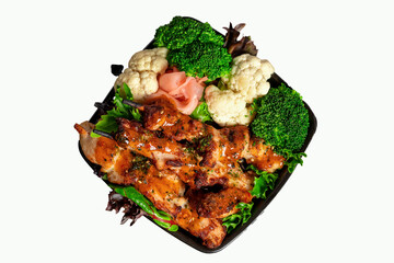 Asisn style chicken  on a bed of  mixed lettuce with steamed fresh vegetables