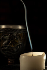 Unlit candles, scene with various objects and recently extinguished candles. Selective focus.