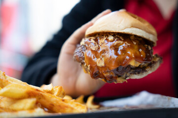 Delicious smashed burger with sauce. Bokeh background.