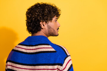 Fototapeta premium Photo portrait of attractive young man back view look empty space dressed stylish blue striped clothes isolated on yellow color background