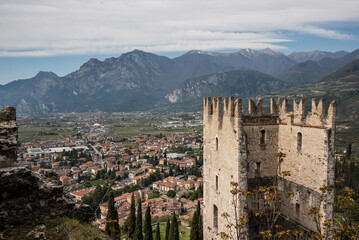 Obraz premium Panoramic view of Arco from ruin of Castello di Arco, Trentino, Italy, nestled between mountains, renowned for its climbing crags and proximity to Lake Garda, a historic Italian town.
