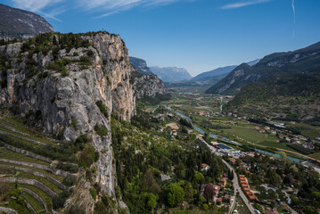 Fototapeta premium Spring view of Valle del Sarca, Trentino, Italy, captured from Castello di Arco, showcasing lush landscapes, mountains, and historic charm