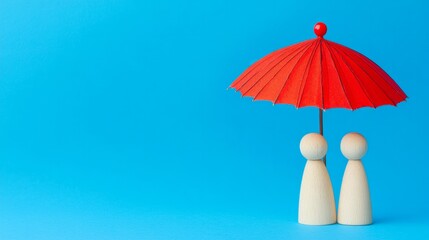 Red toy umbrella with wooden dolls on a blue background.

