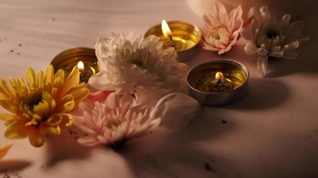 Celebration of Diwali or Deepavali holiday in India with candles and flowers in the evening at night close-up. Hindus celebrate the festival of lights