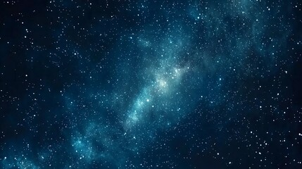 Fototapeta premium A dark blue starry sky with a bright galaxy in the center.