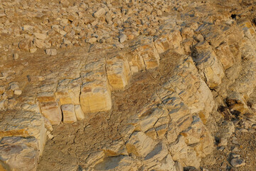 The abstract shapes, patterns and textures of the limestone surface appear to be layered.Natural pattern and texture background. Copy space.Limestone wall on the edge of the lake. For graphic design 