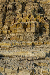 The abstract shapes, patterns and textures of the limestone surface appear to be layered.Natural pattern and texture background. Copy space.Limestone wall on the edge of the lake. For graphic design 